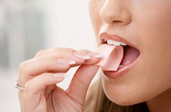a girl eating chewing gum