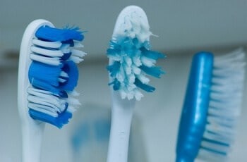 Brushing teeth as part of oral hygiene