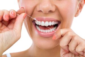 lady-brushing-and-flossing-her-gums